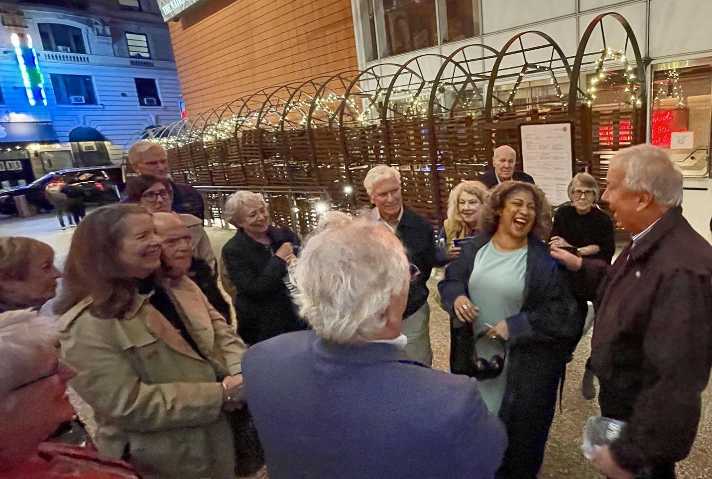 Photo of a group of people next to a brick building laughing with a Broadway actress 